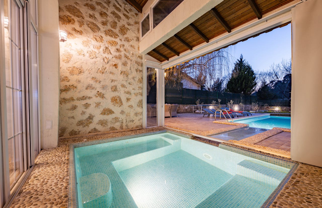 Elegant scene of a modern indoor-outdoor pool setting, perfect for relaxation.